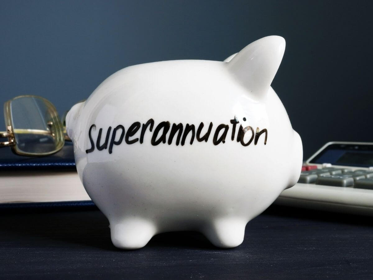 A white piggy bank on a desk representing superannuation savings