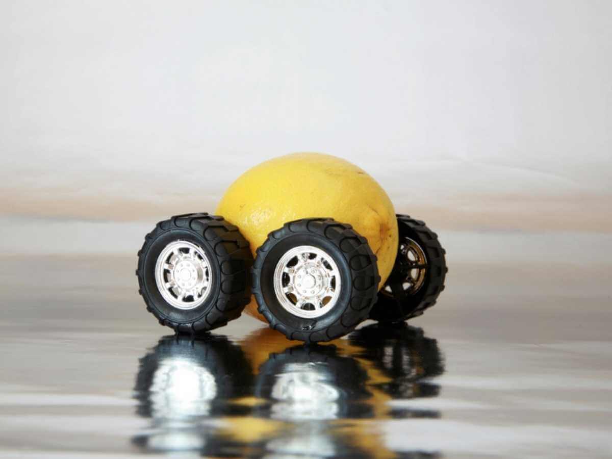 Image of a lemon with toy car wheels attached