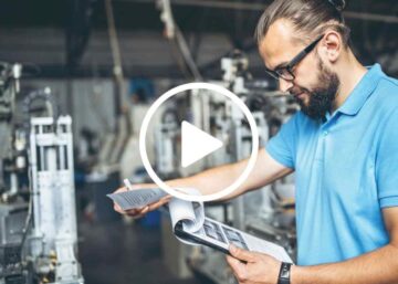 a man reading a book in a factory