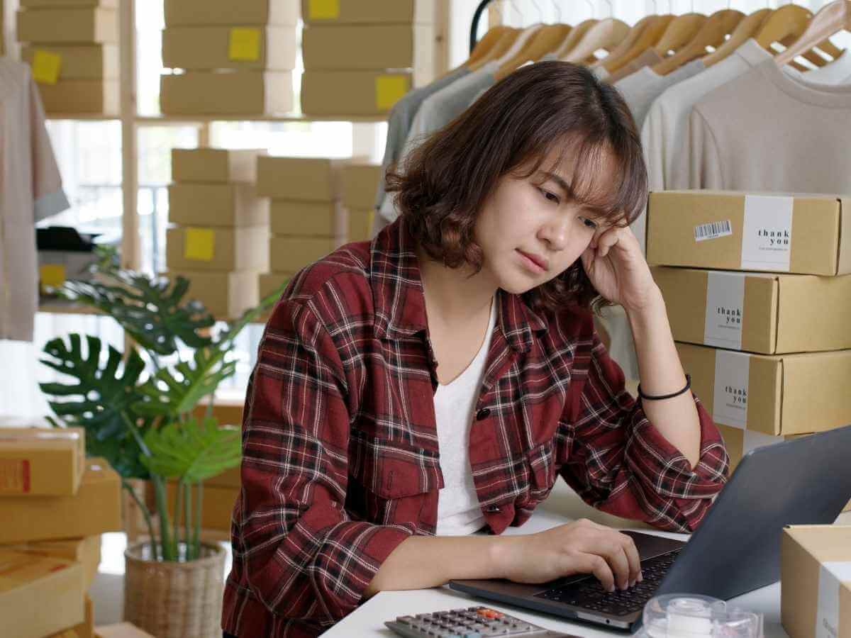 Young female business owner feeling stressed about financial problems