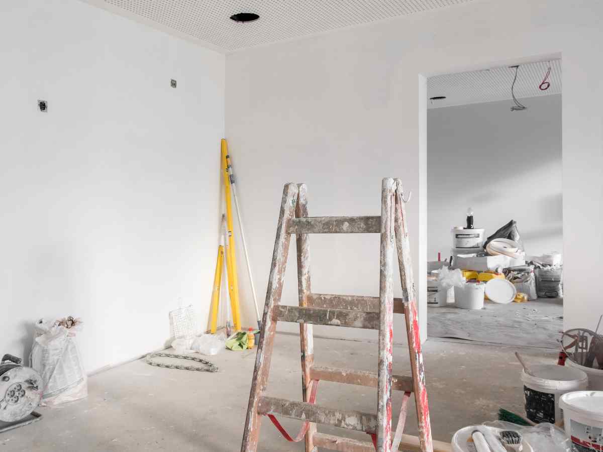 Rental property expenses | image of the interior of a property under renovation with ladders, tools and paint cans
