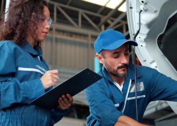 120% Training and Technology boosts | A male mechanic training a young female apprentice in a workshop