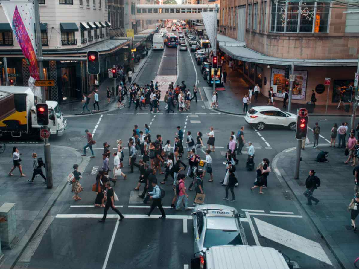 People crossing a city intersection in Sydney Australia viewed from above.