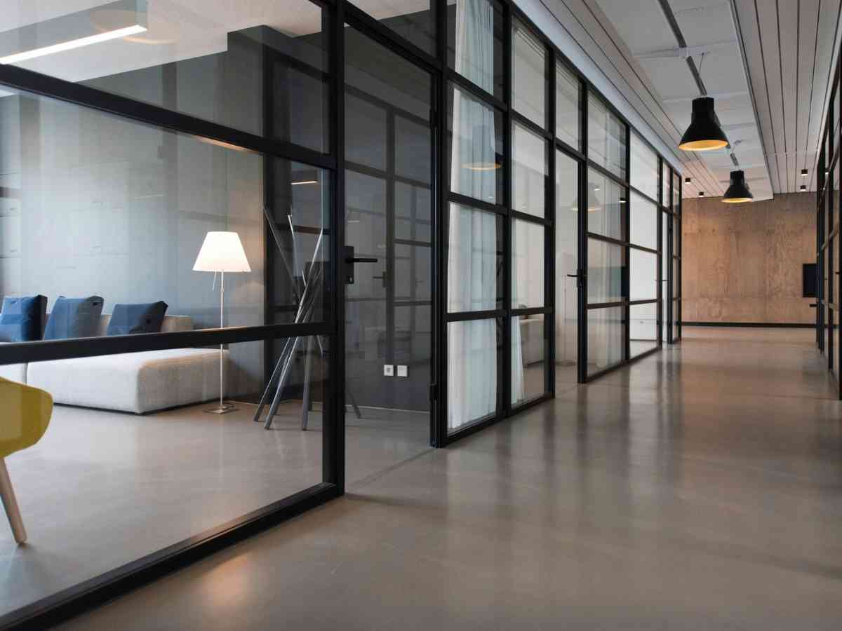 The interior of a commercial office building showing glass panel partitions between offices