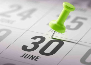A close up of a calendar showing the 30 June date marked with a green thumb tack.