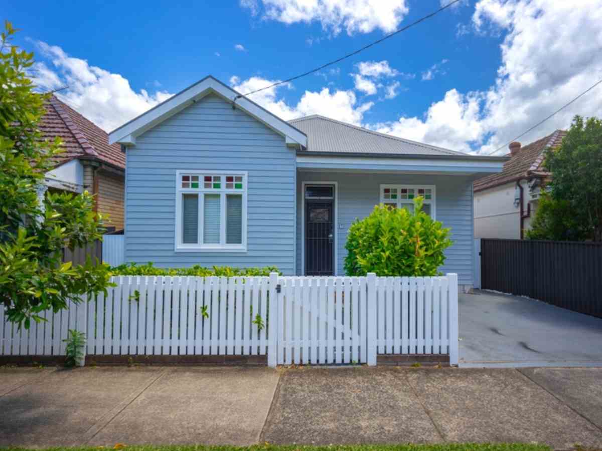 Inheriting property | a modest blue timber suburban home with a white picket fence